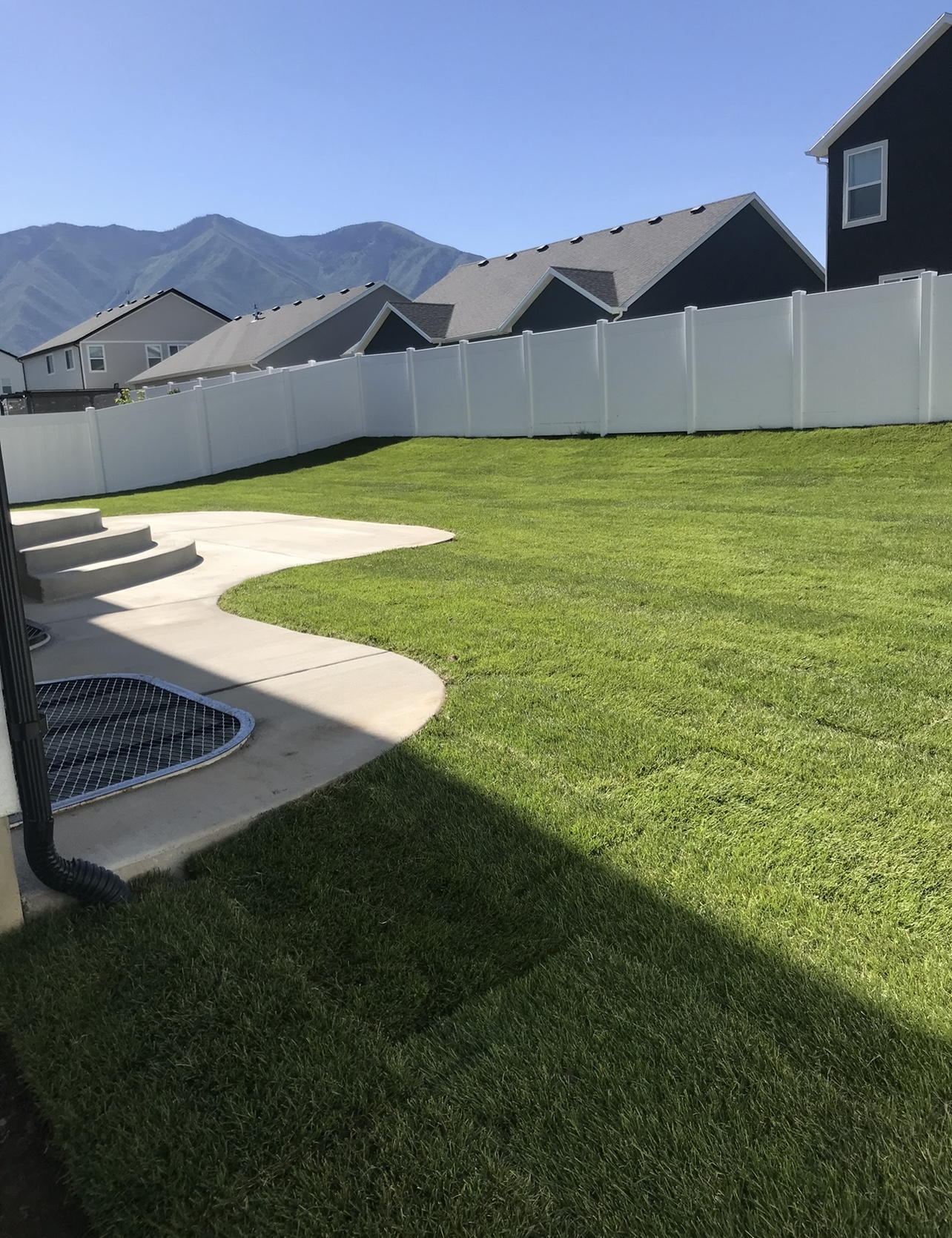 Backyard lawn area after sod installation and clean landscape finish in Utah