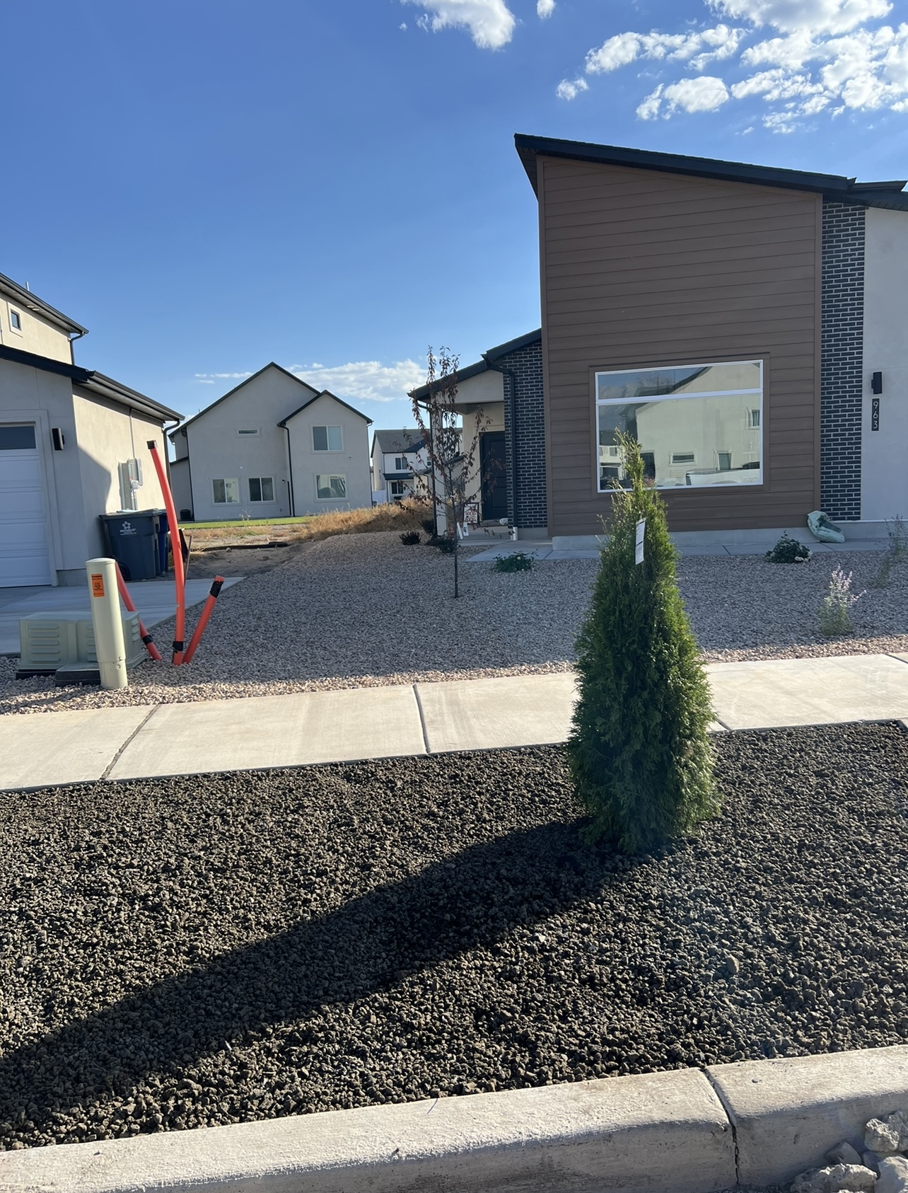 Finished front yard rock landscaping installation with clean curb appeal in Utah