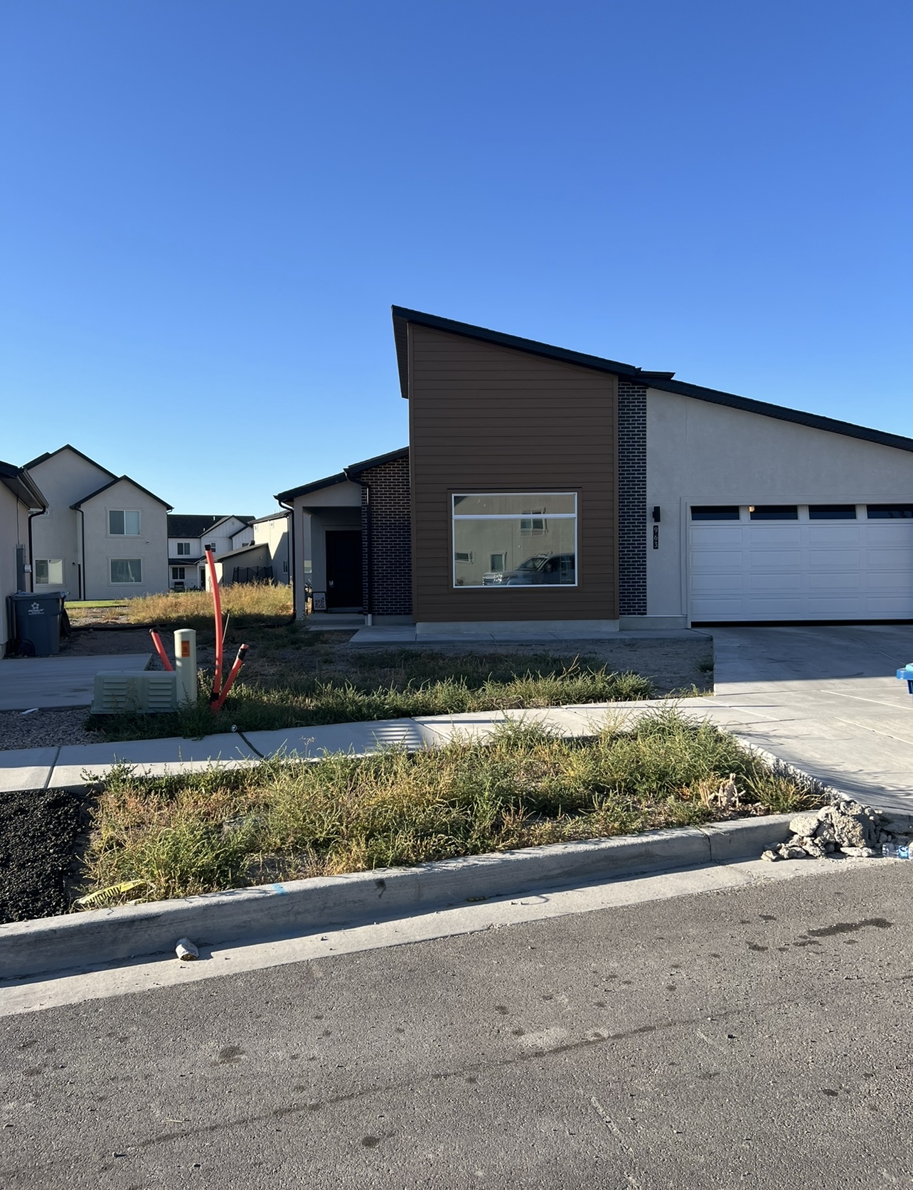 Front yard rock landscaping before cleanup and weed barrier installation in Utah
