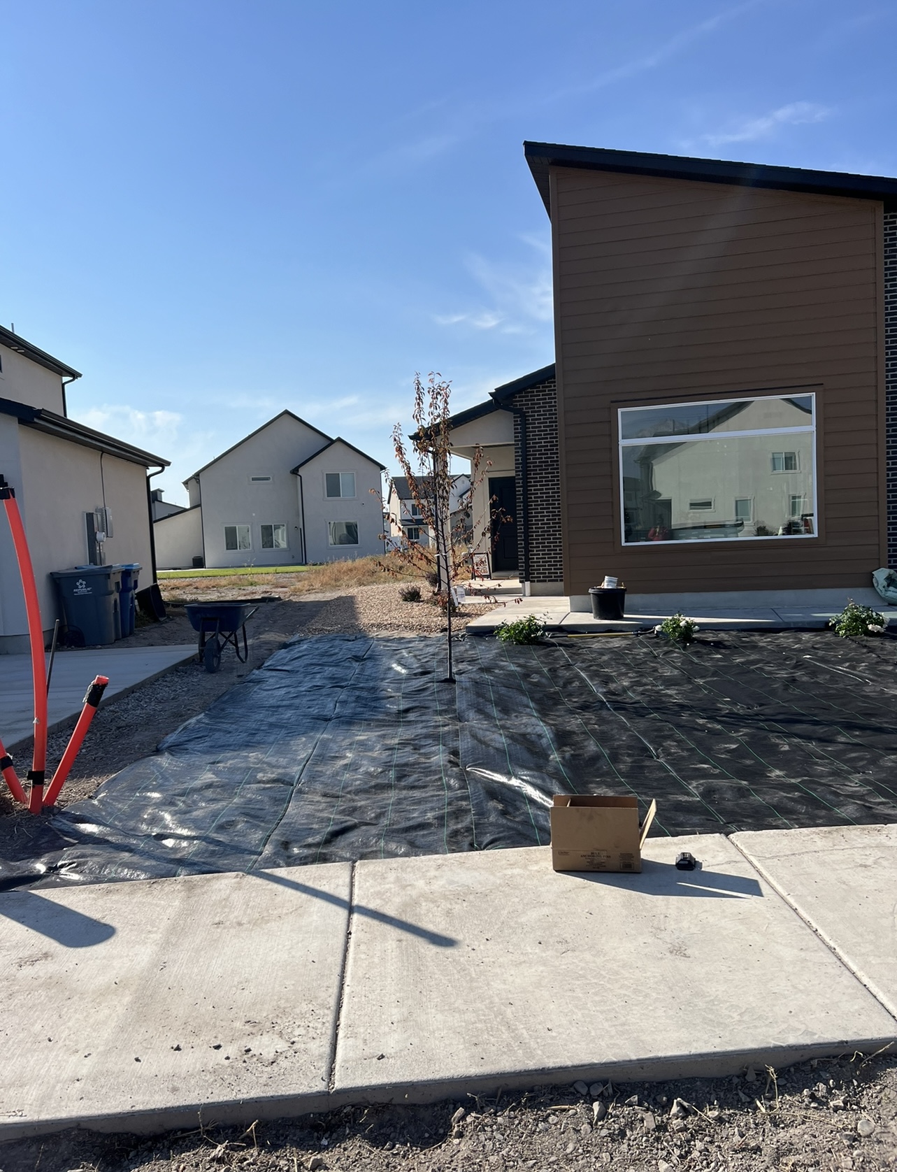 Front yard rock landscaping with weed barrier preparation in Utah