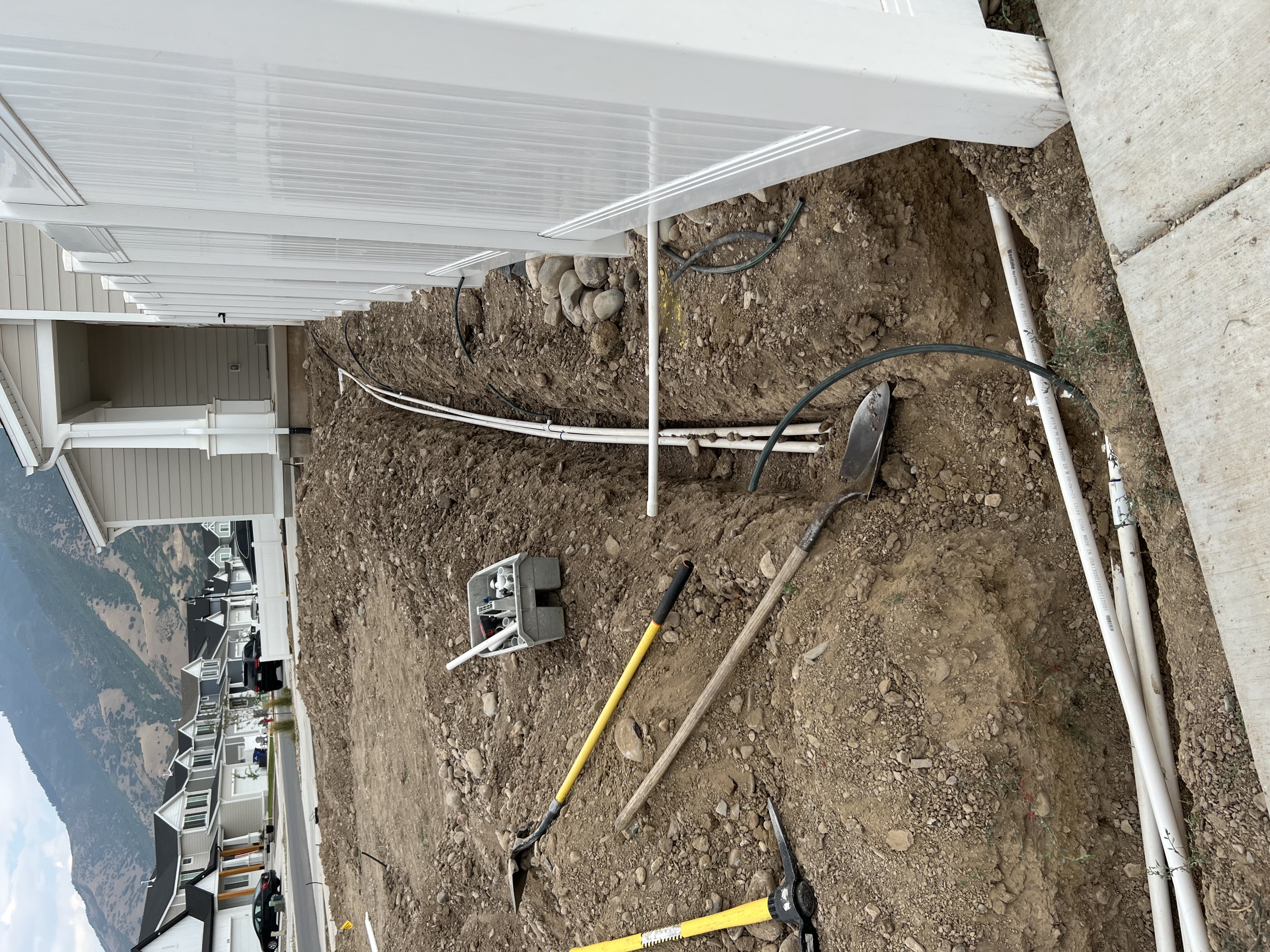 New build corner lot sprinkler trenching during landscape installation in Utah