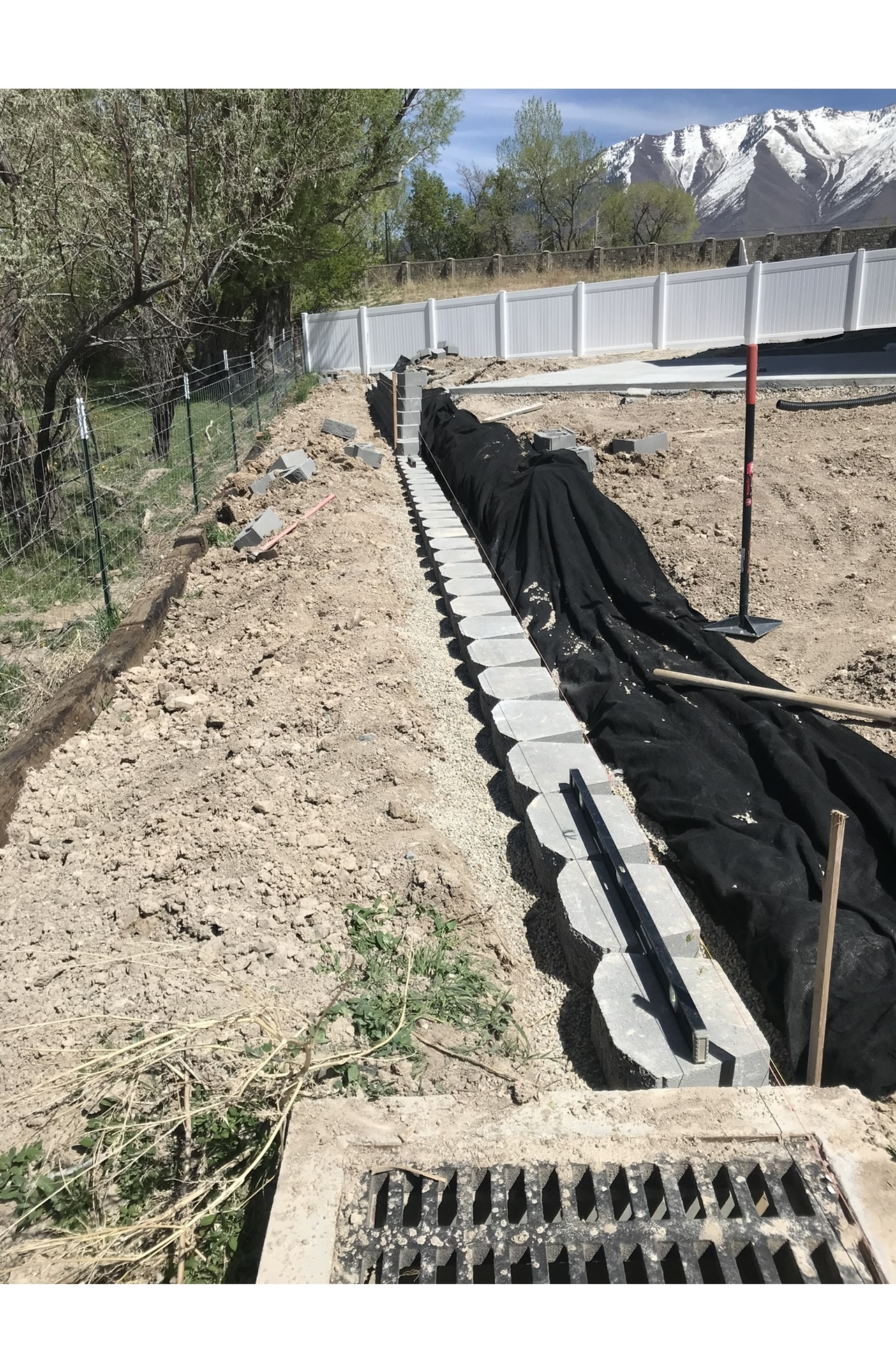 Retaining wall installation before landscape work in Utah yard