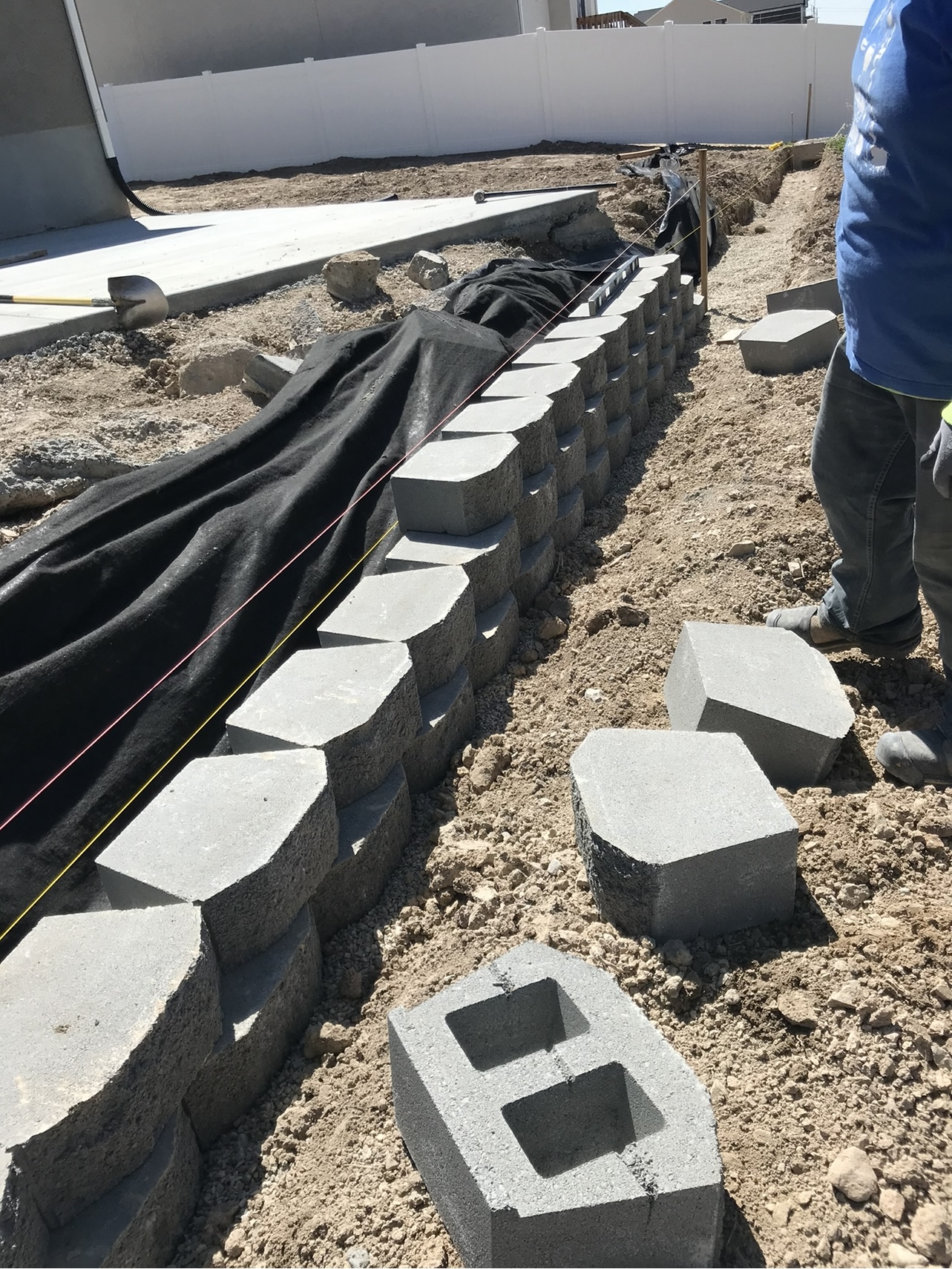 Retaining wall installation site preparation before landscape finish in Utah