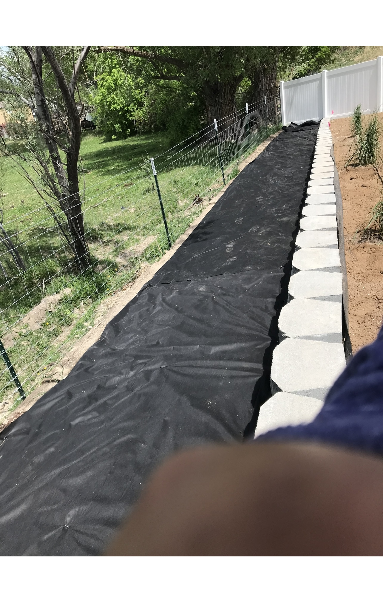 Retaining wall installation before mulch finish in Utah